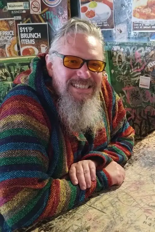 Marcus, founder of Rapid Speech Therapy, smiling at a café table